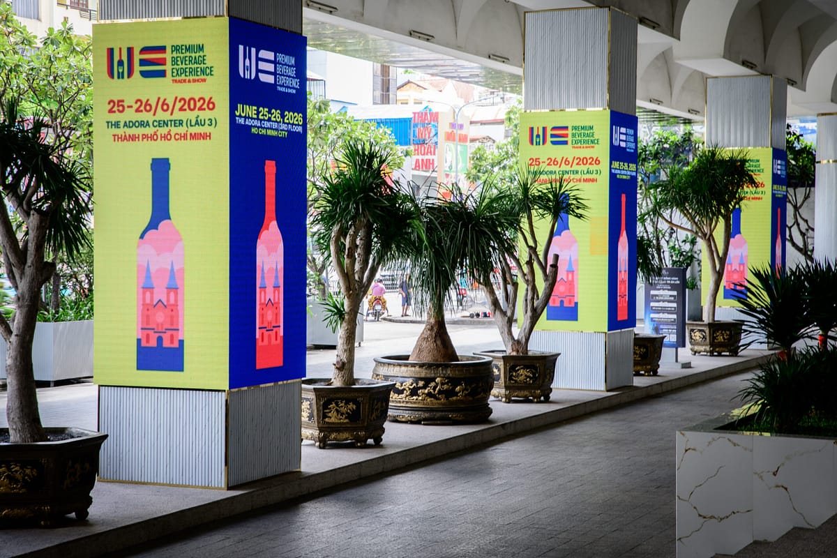 Wines Experience Premium Beverage Experience promotional banners on the pillars outside the Adora Center, Ho Chi Minh City, June 25-26, 2026