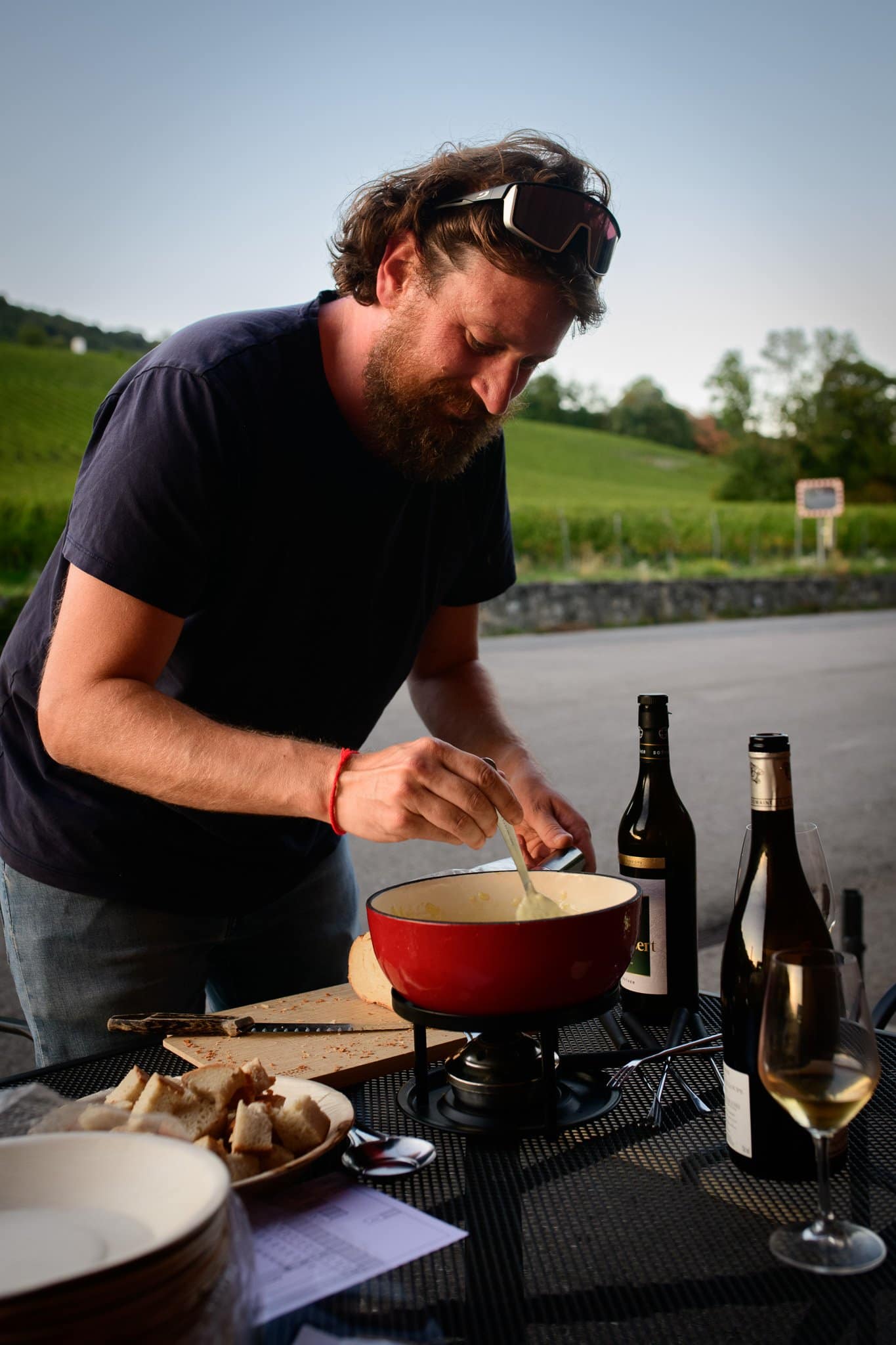 Maxime Sother stirs the cheese fondue.