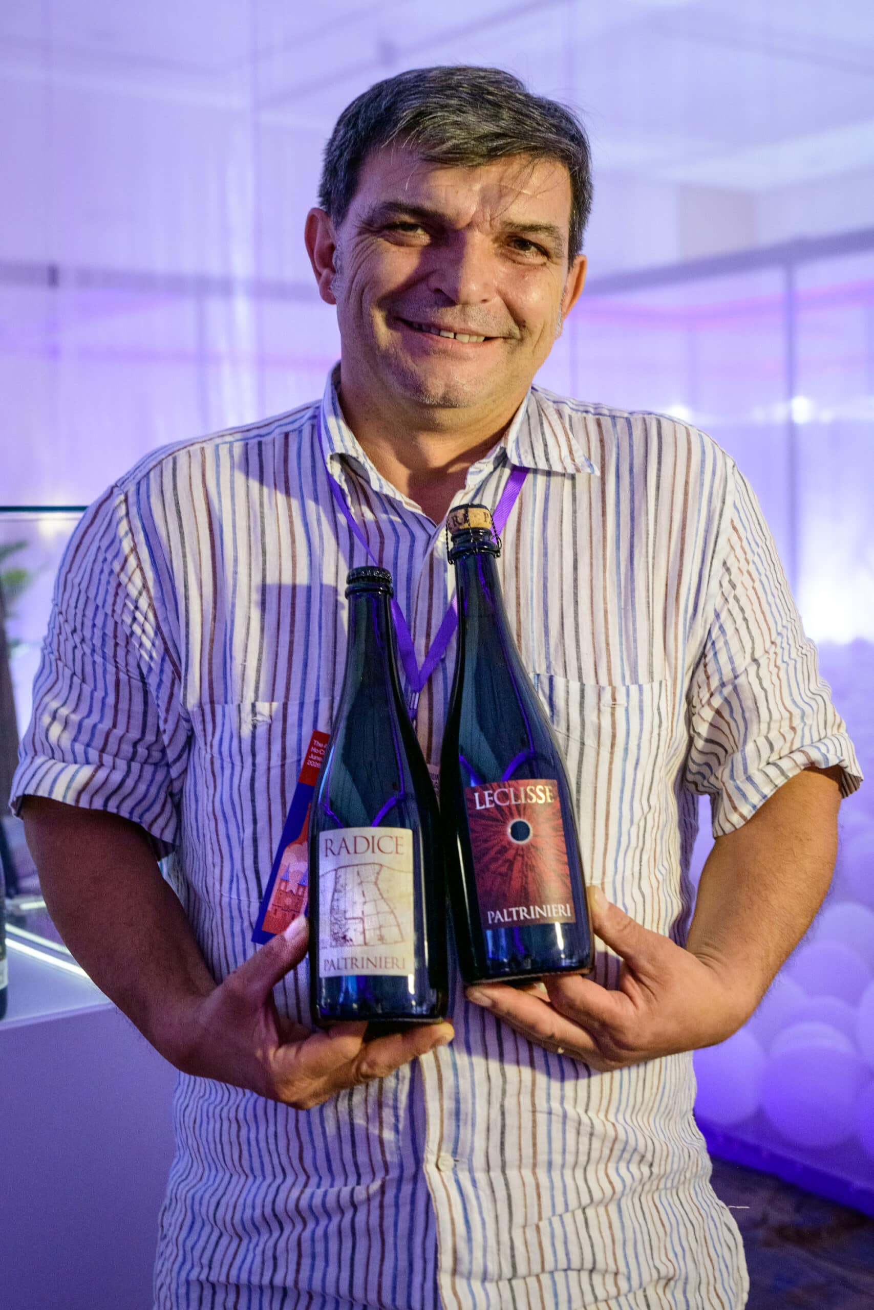 Alberto Paltrinieri of Cantina Paltrinieri, Emilia-Romagna, holding his Radice and Leclisse Lambrusco di Sorbara bottles at Wines Experience Ho Chi Minh City 2026