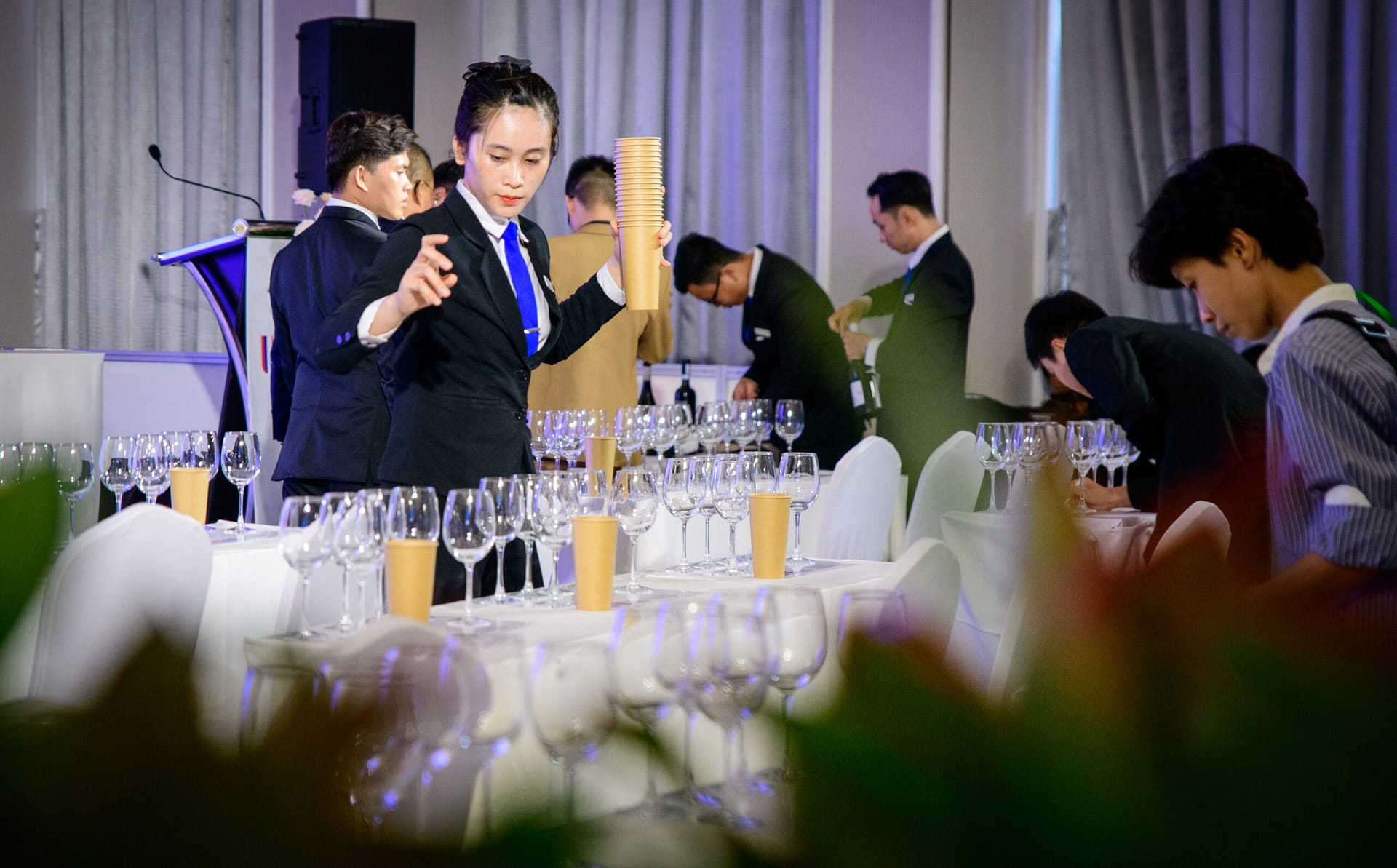 Staff setting up wine glasses for a masterclass session at Wines Experience HCMC 2026, Adora Center