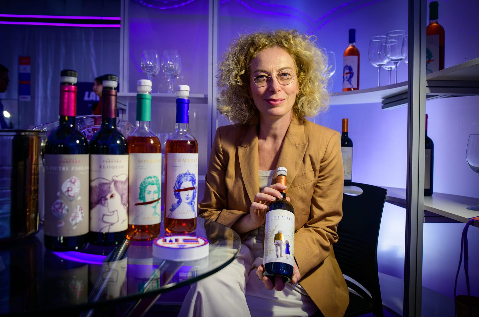 Maria Faretra, founder of Cantina Maria Faretra from Puglia, at her booth at Wines Experience Ho Chi Minh City 2026, with her organic wine lineup