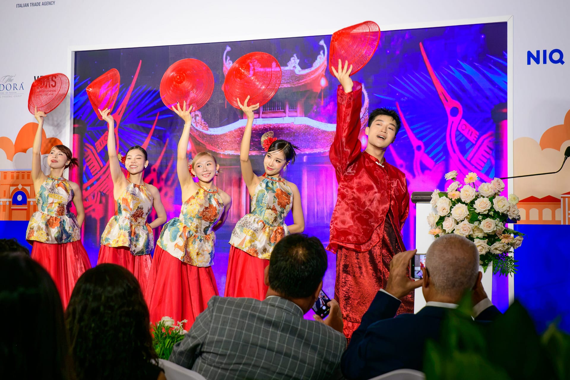 Vietnamese dancers performing with red decorative fans at the opening ceremony of Wines Experience Ho Chi Minh City 2026